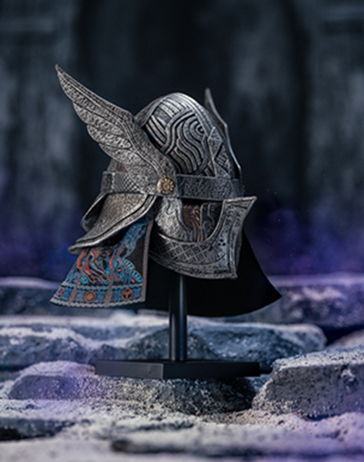 Detailed decorative helmet with wings displayed on a stand.