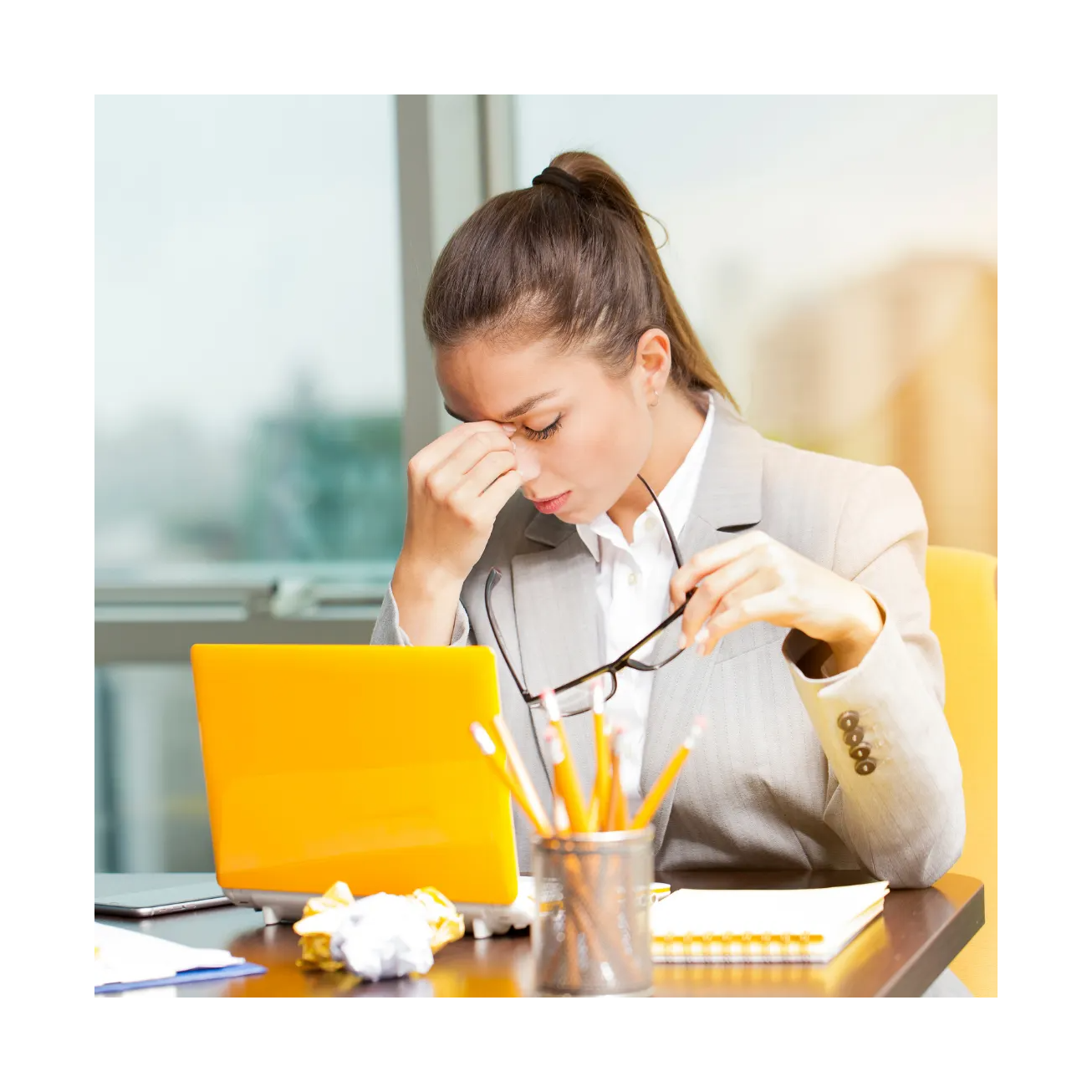 Woman stressed working on laptop