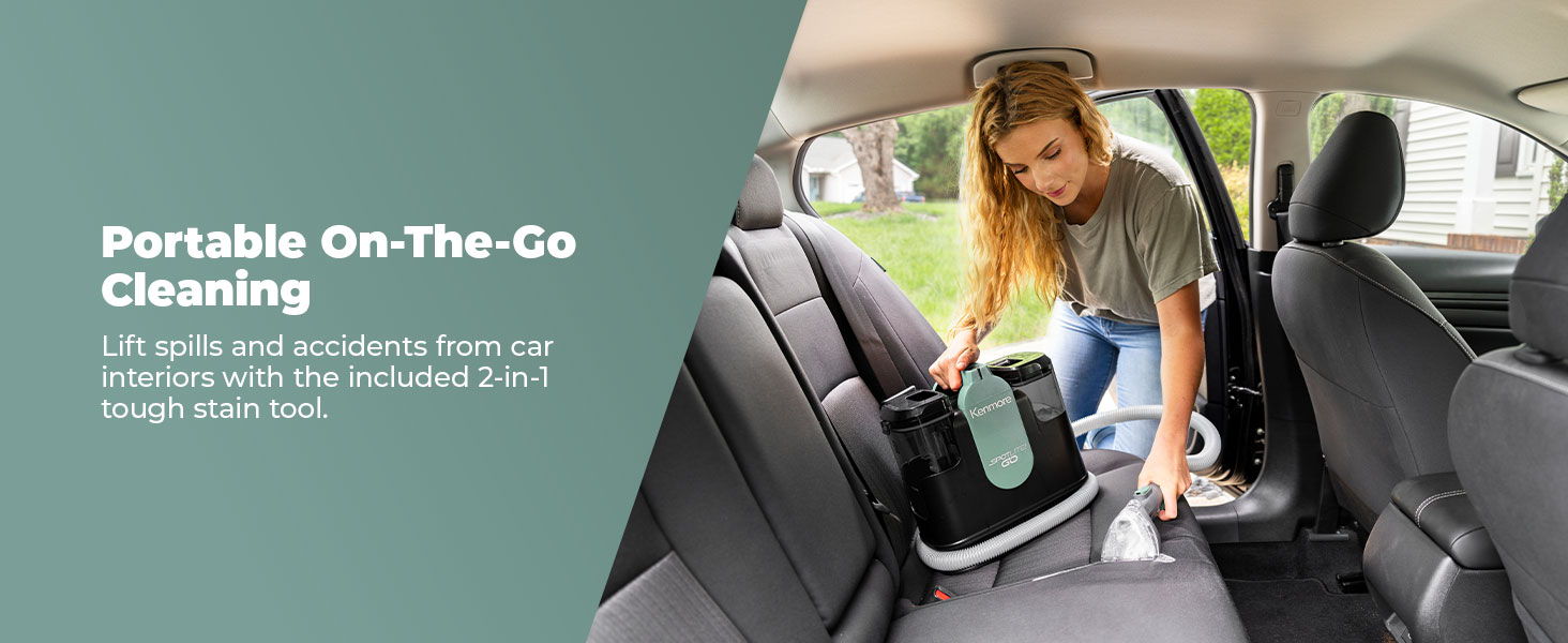 Person cleaning a car interior with a portable spot cleaner