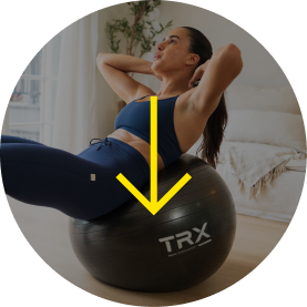Woman exercising on a stability ball in a bright, indoor setting.