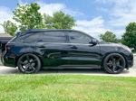 Side profile Carrie's black 2017 Acura MDX with chrome delete and black wheels on driveway photo 2