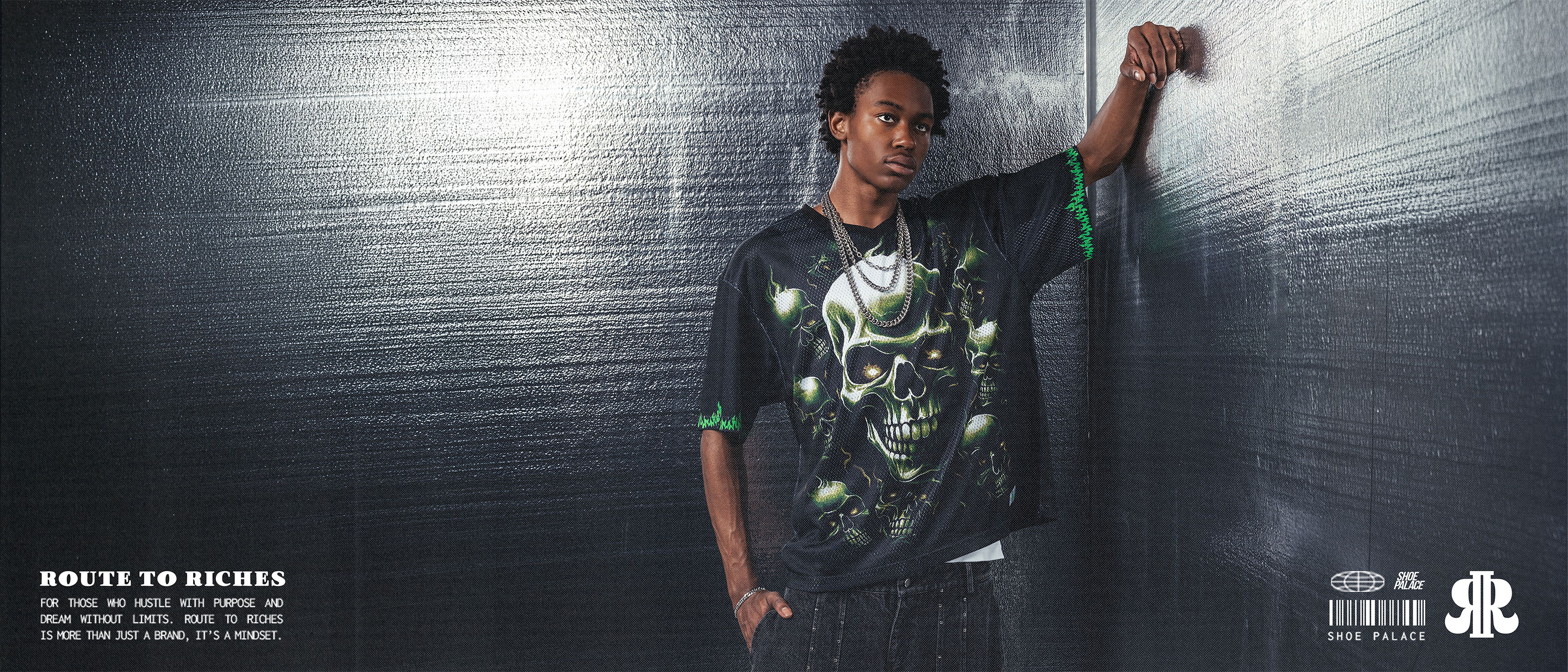 Young person in a graphic t-shirt posing against a dark background.