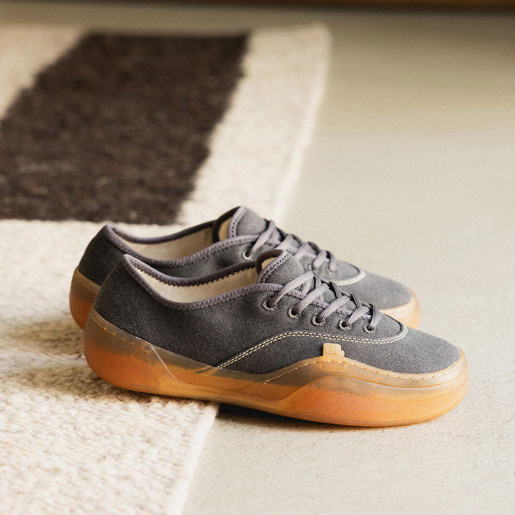Gray shoes with gum soles on a carpeted surface.