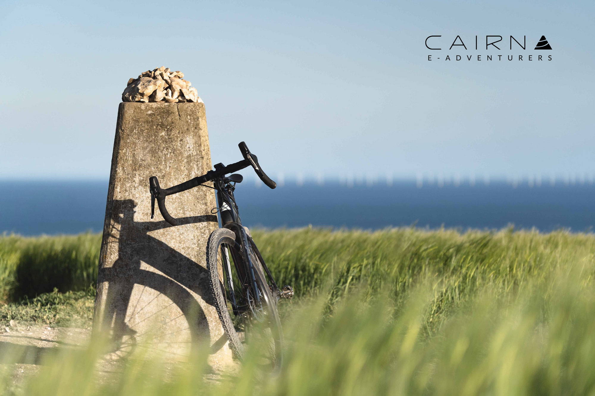 Cairn bike leant against a trig point