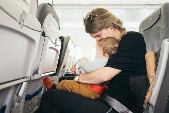 Mother With Baby On Plane