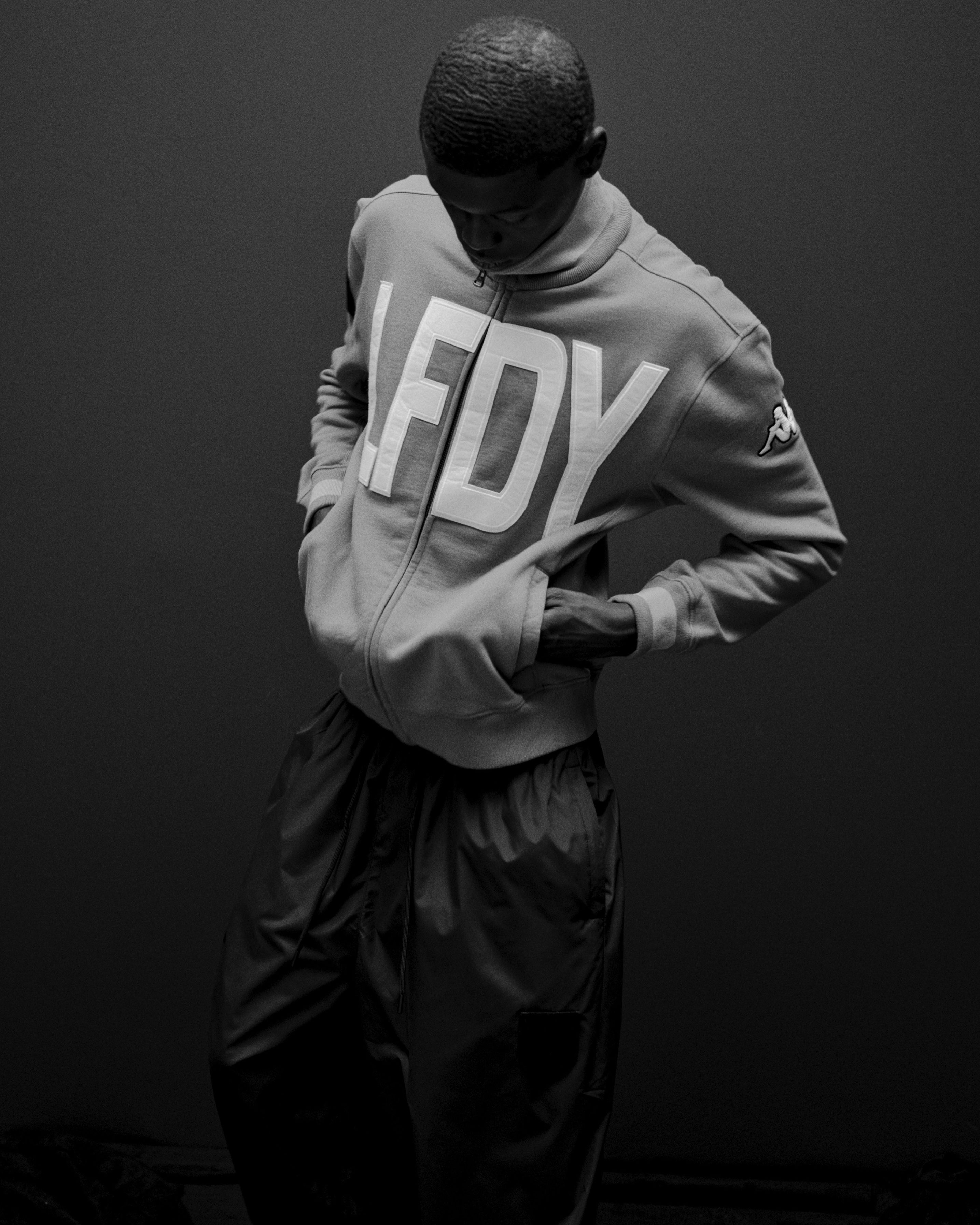 Person wearing a gray hoodie with 