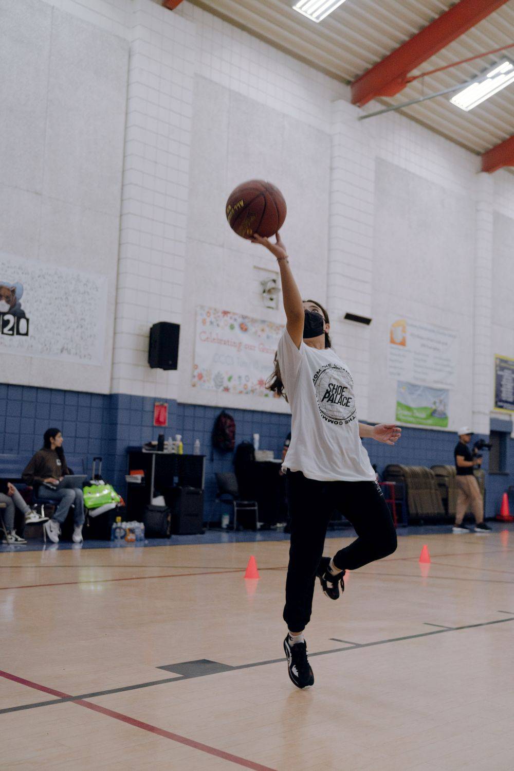 girl doing a layup in basketball