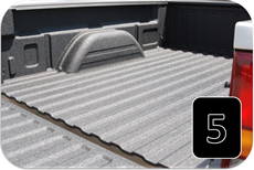 Completed spray-on bedliner on a pickup truck after masking is removed
