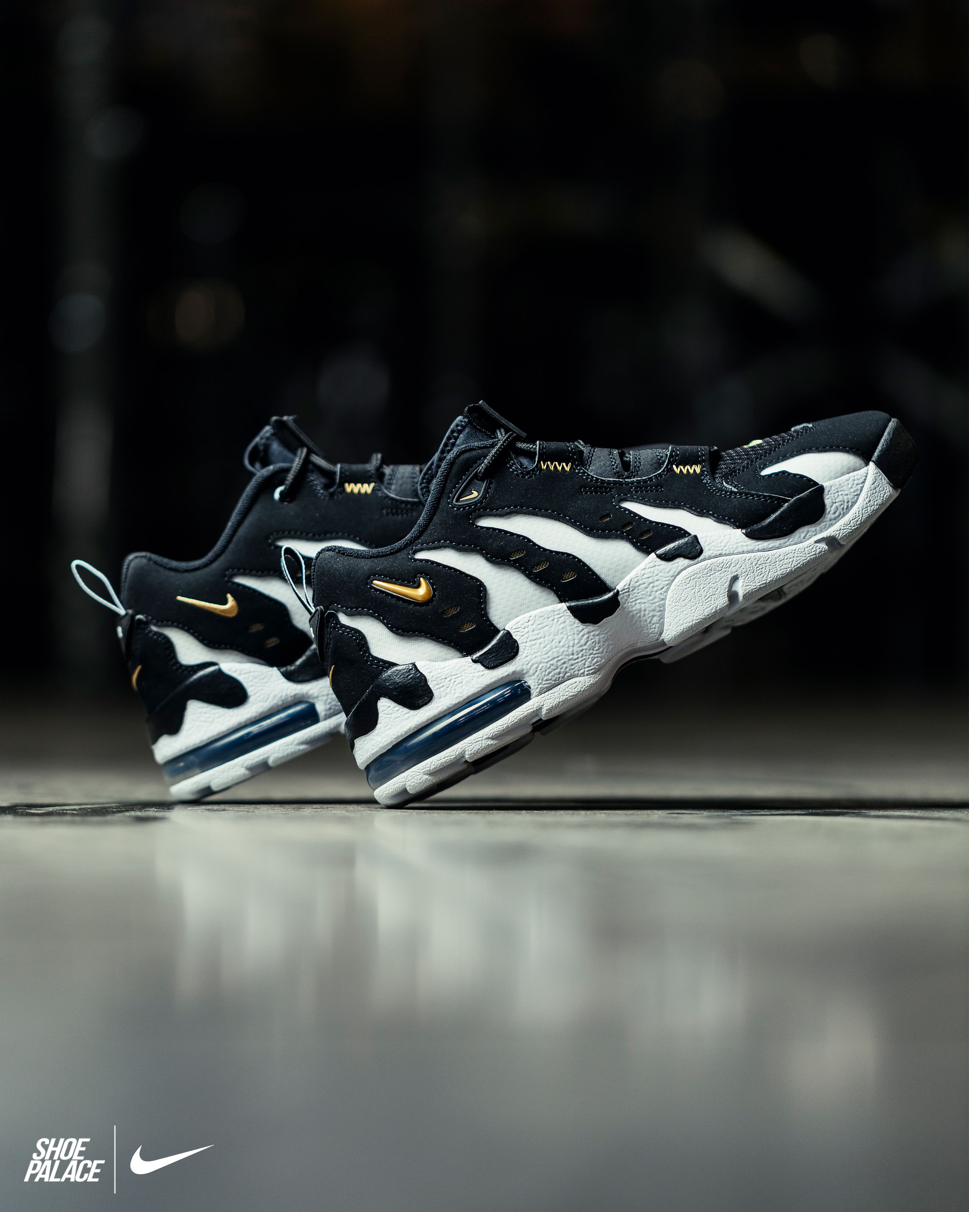 Black and white Nike sneakers displayed against a blurred background.