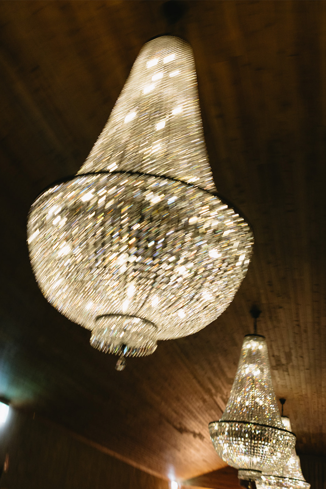 Chandeliers hanging from the ceiling, sparkling with light reflections.