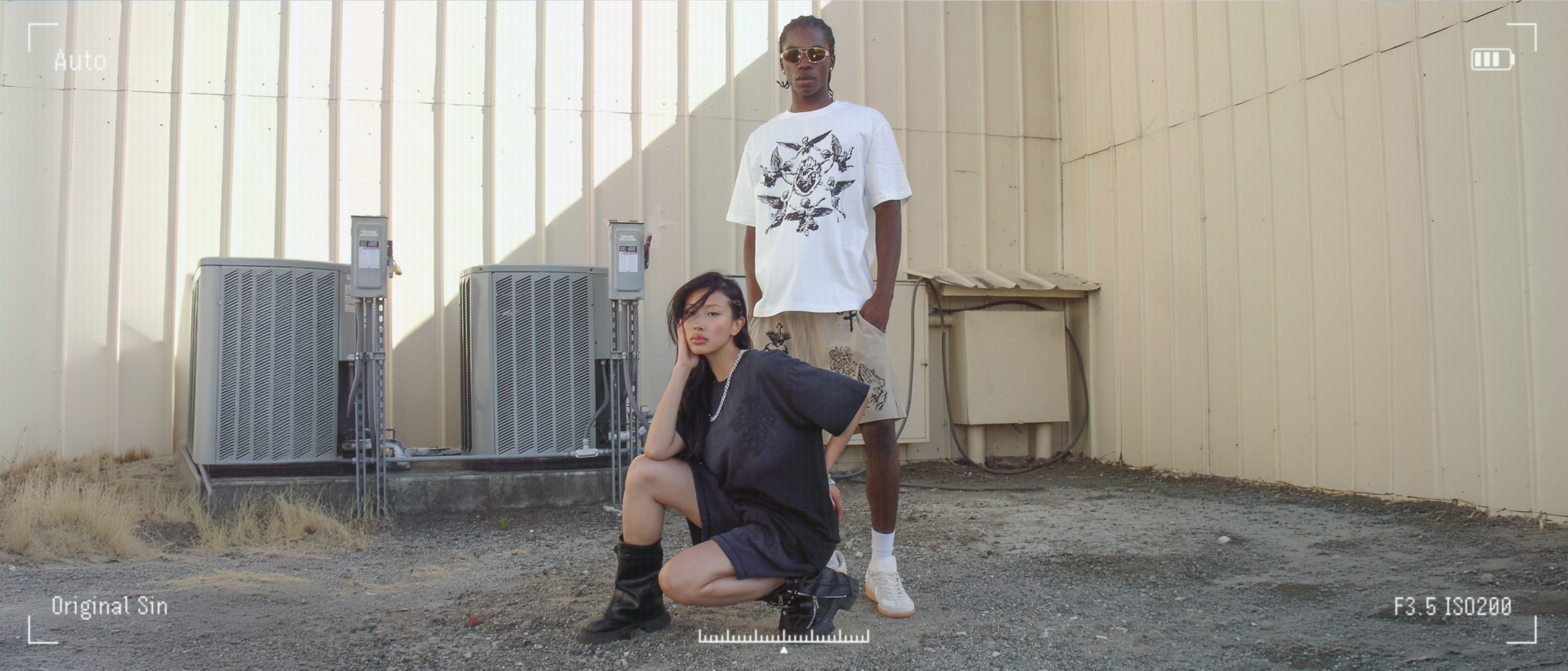 Two individuals posing outdoors in a casual setting.
