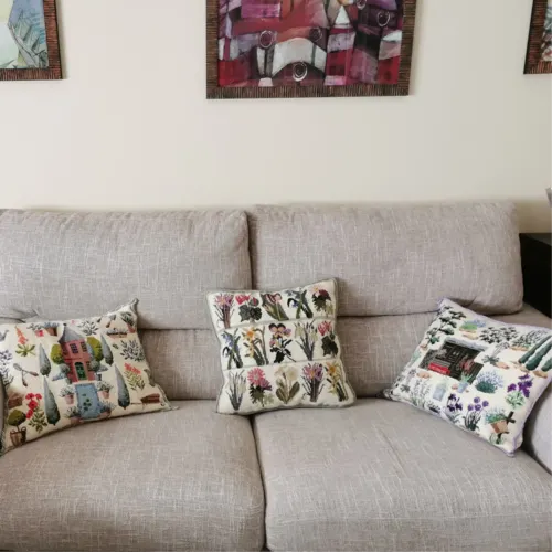 3 needlepoint cushions on a couch