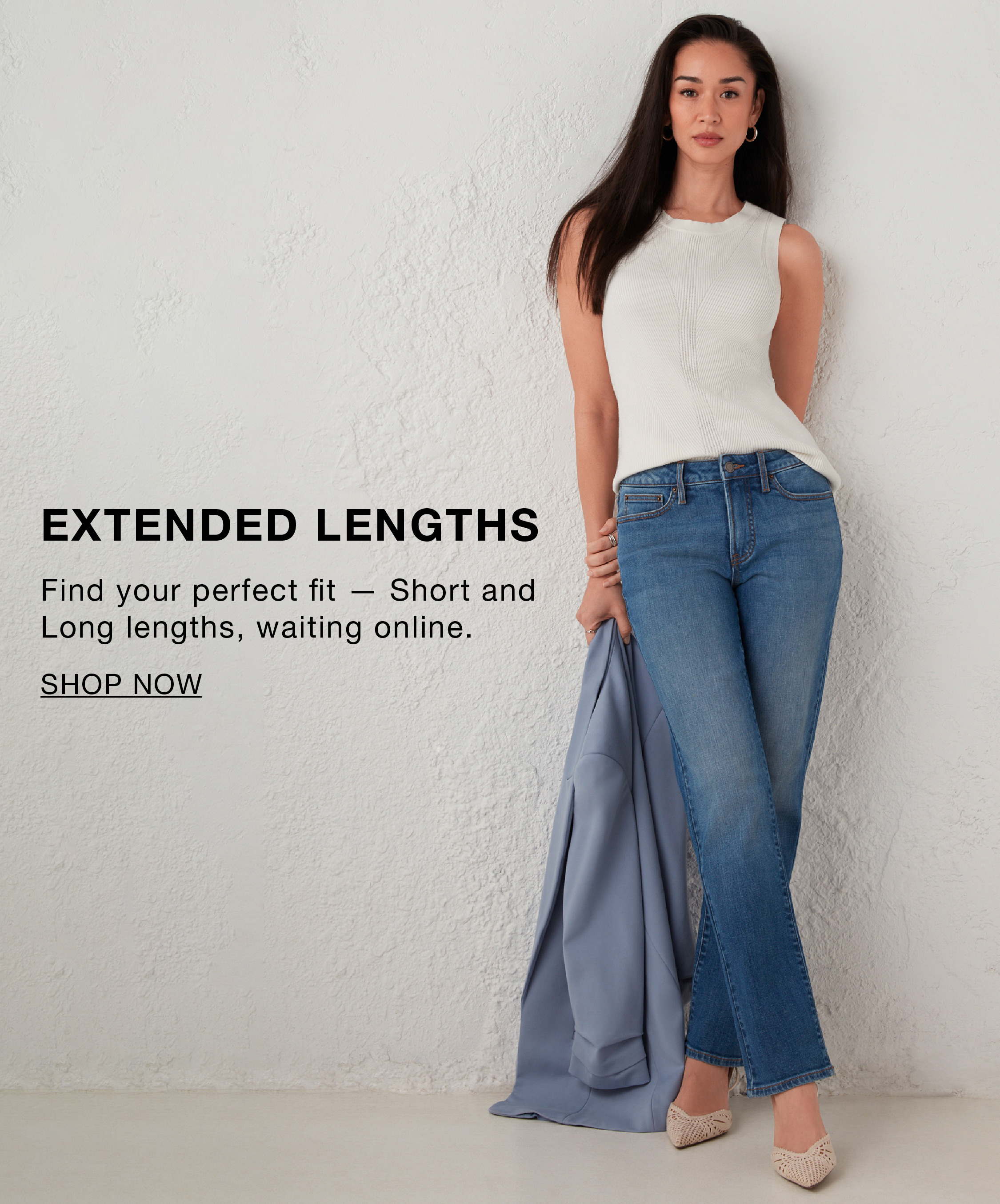 Woman in casual outfit promoting extended lengths for jeans.