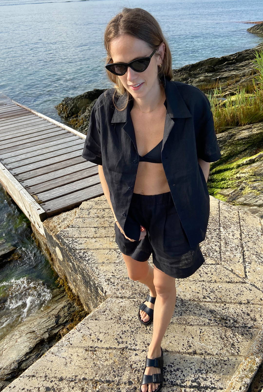 Poppy wearing black linen shirt and black linen shorts