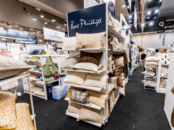 Pillows displayed on shelves in a retail setting.