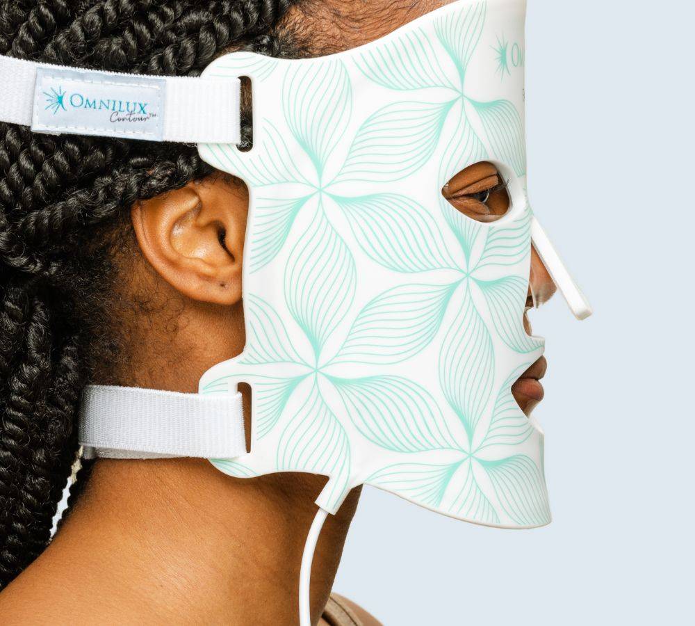 Side view of woman wearing Omnilux Contour Face LED Light Mask