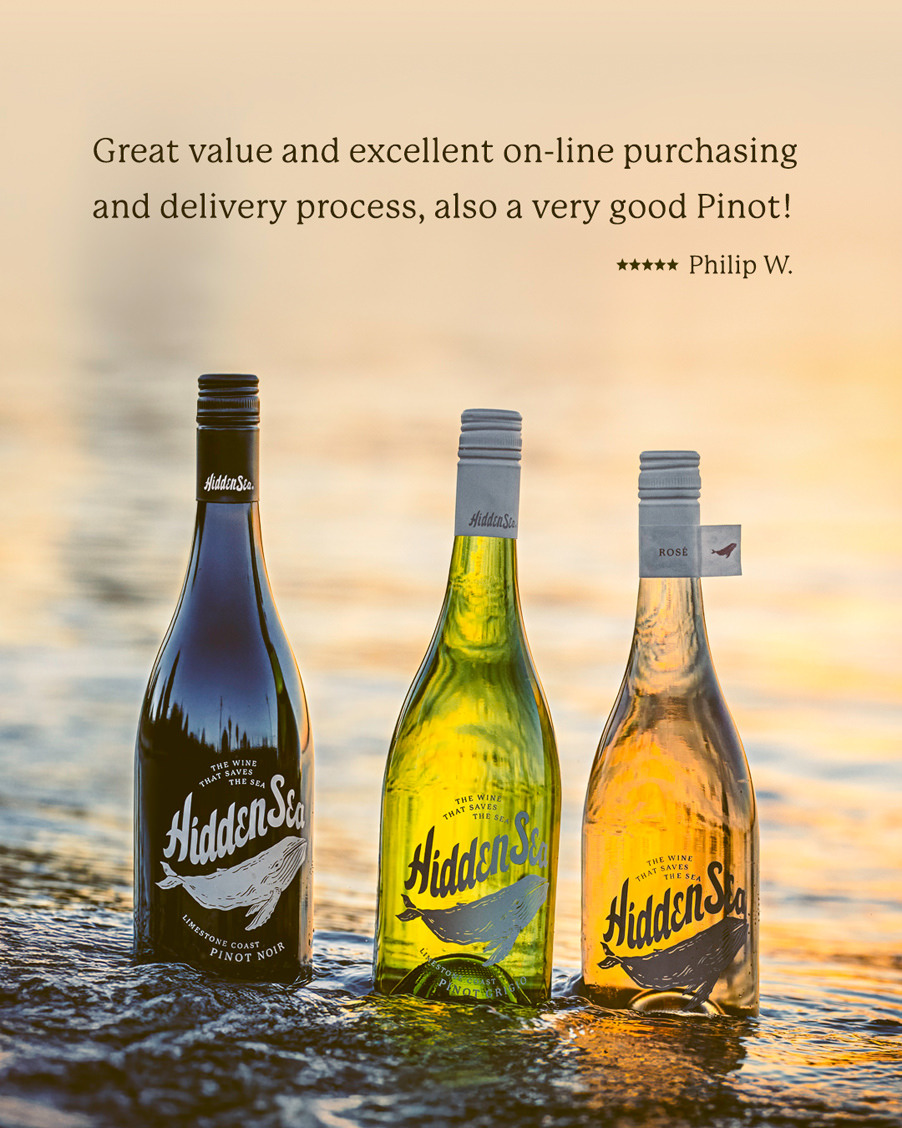 Three The Hidden Sea bottles standing in shallow ocean water at sunset with a 5-star review quote praising value, online purchasing, and delivery — Philip W.