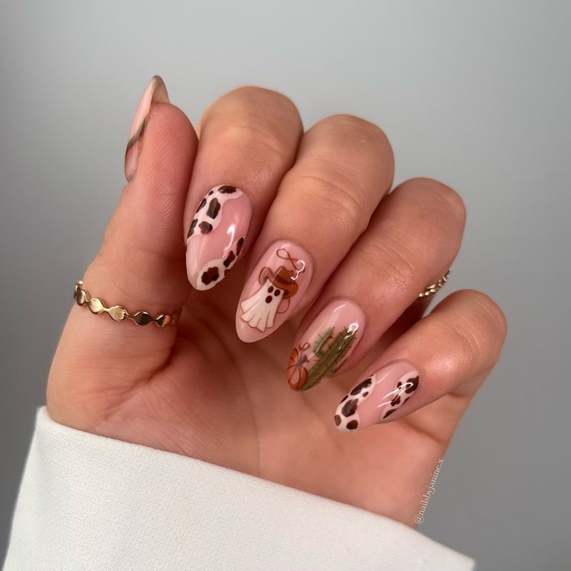 A hand showing nails with pink and brown designs.