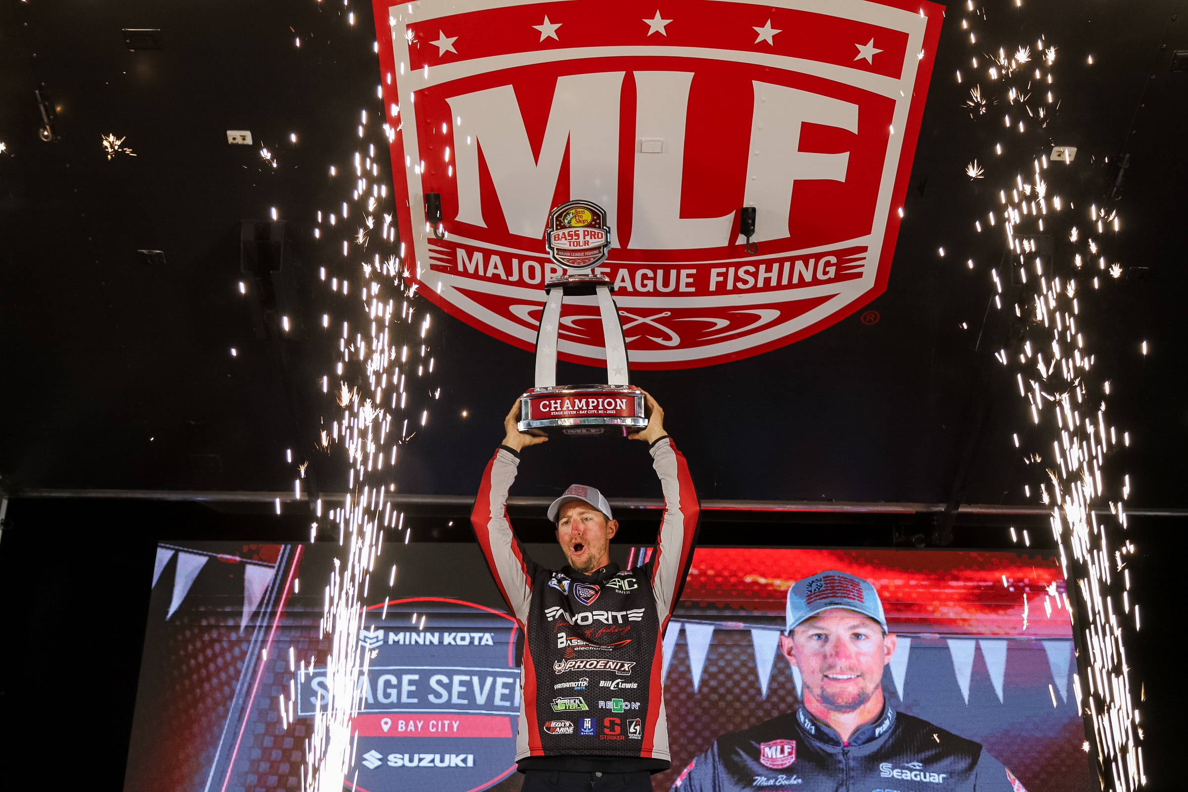 Matt Becker hoists the stage Seven Trophy