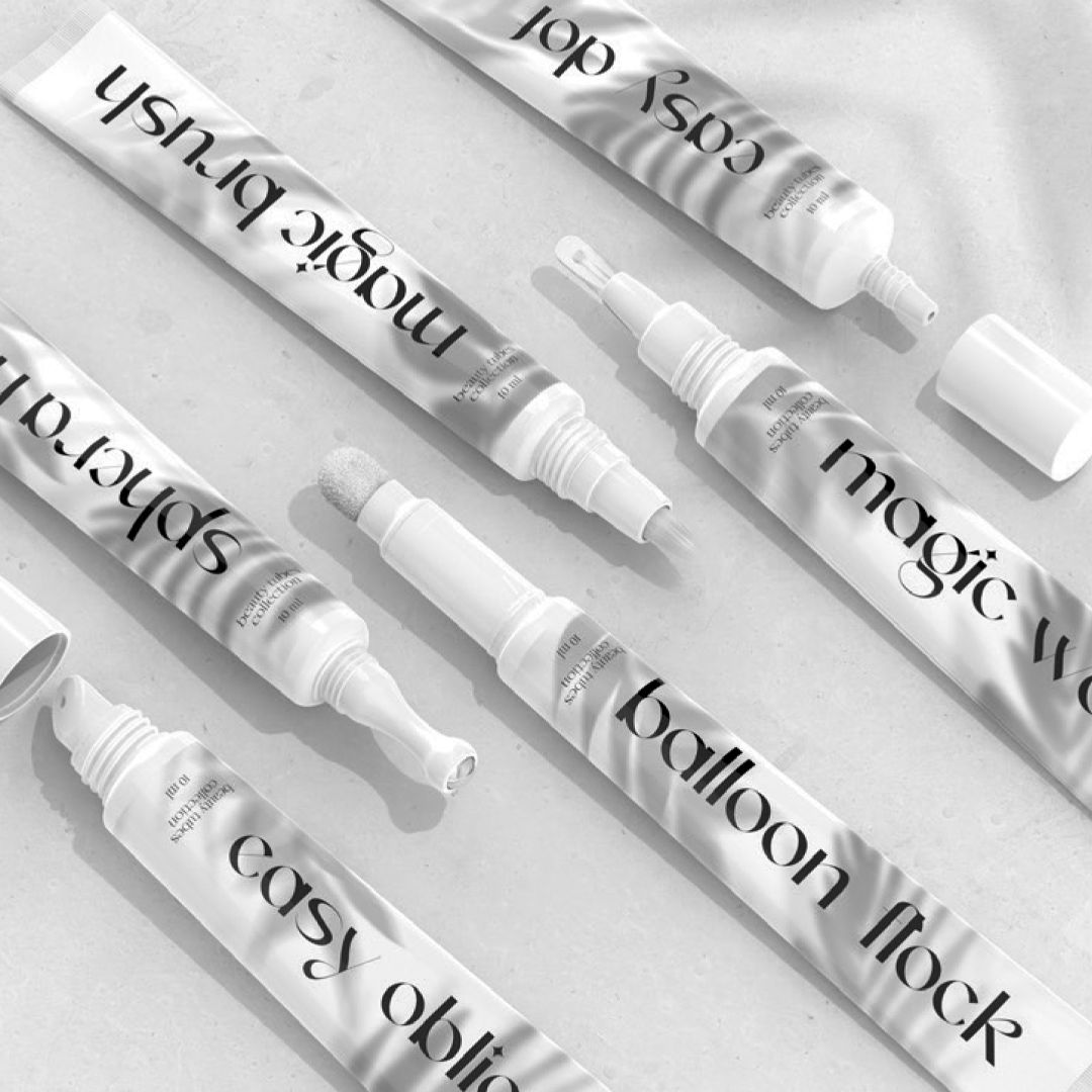 Various cosmetic tubes arranged on a flat surface.