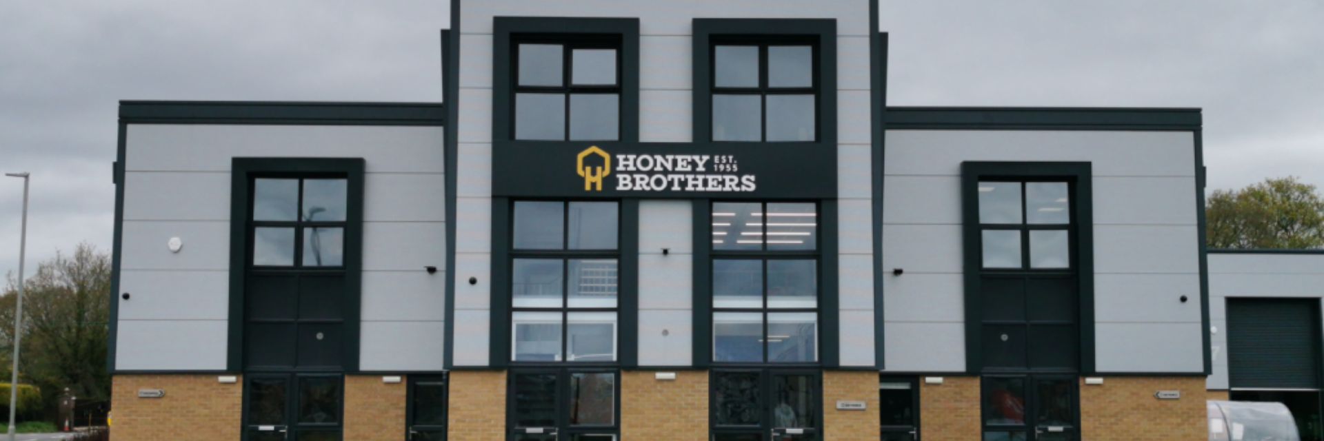 Modern commercial building with large windows and a prominent sign.