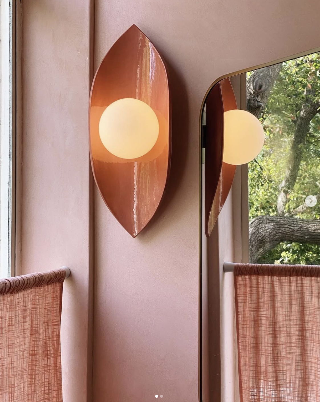Curved Ceramic Wall Light | Pod on a light red wall