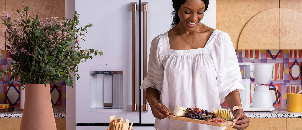 Woman with Cheese Board in Kitchen