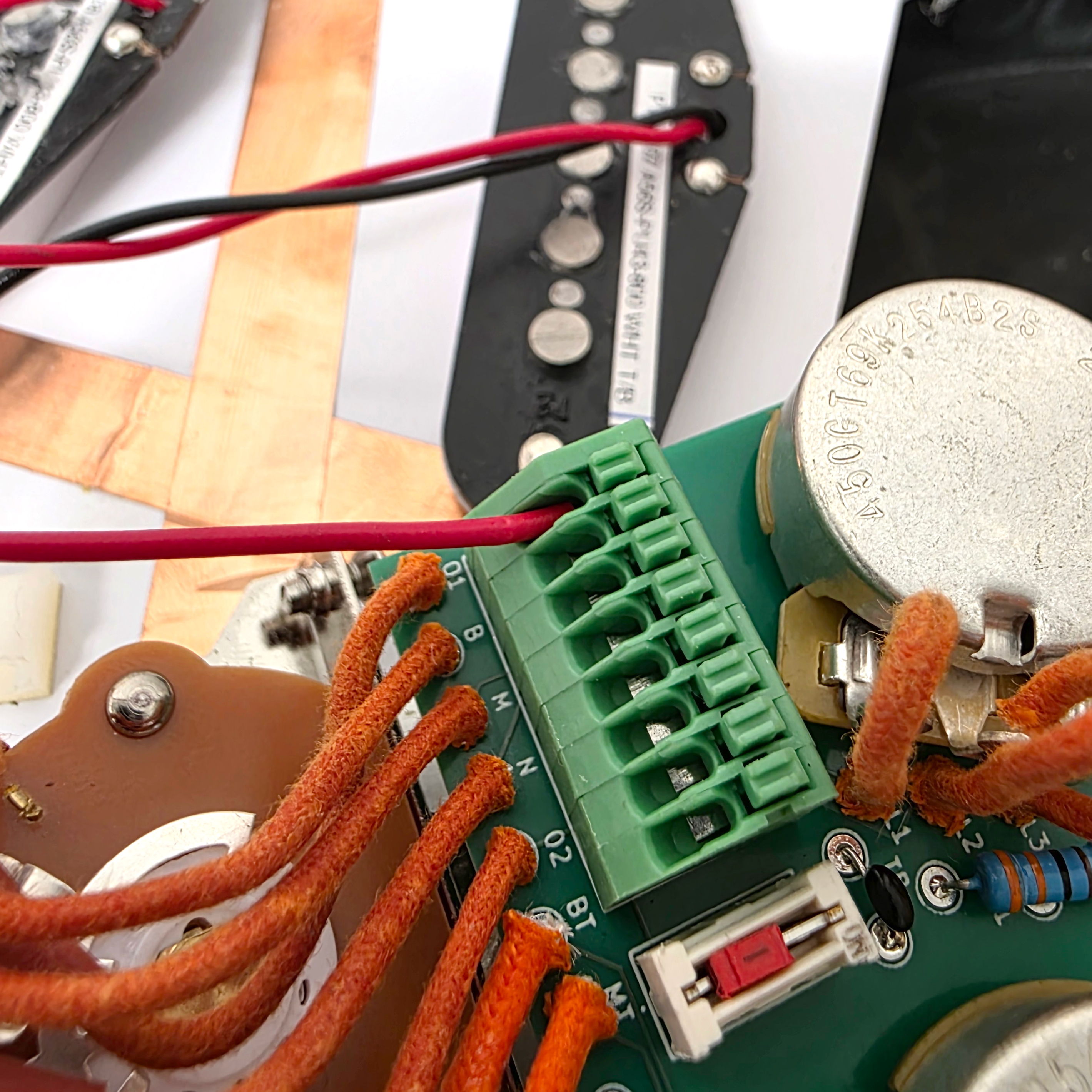 Close-up of circuit board with wires and electronic components.
