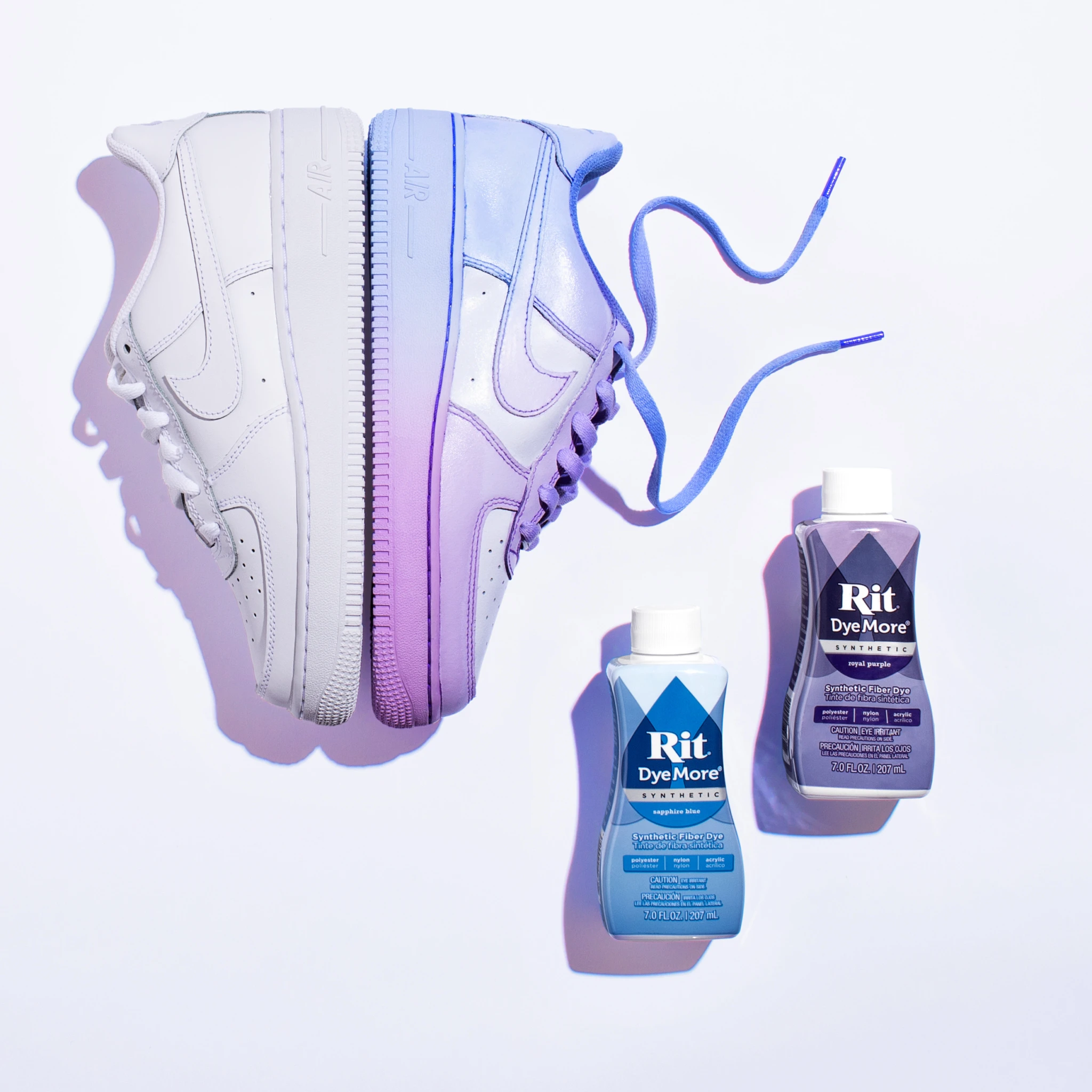 White sneakers with purple dye bottles on a white background.