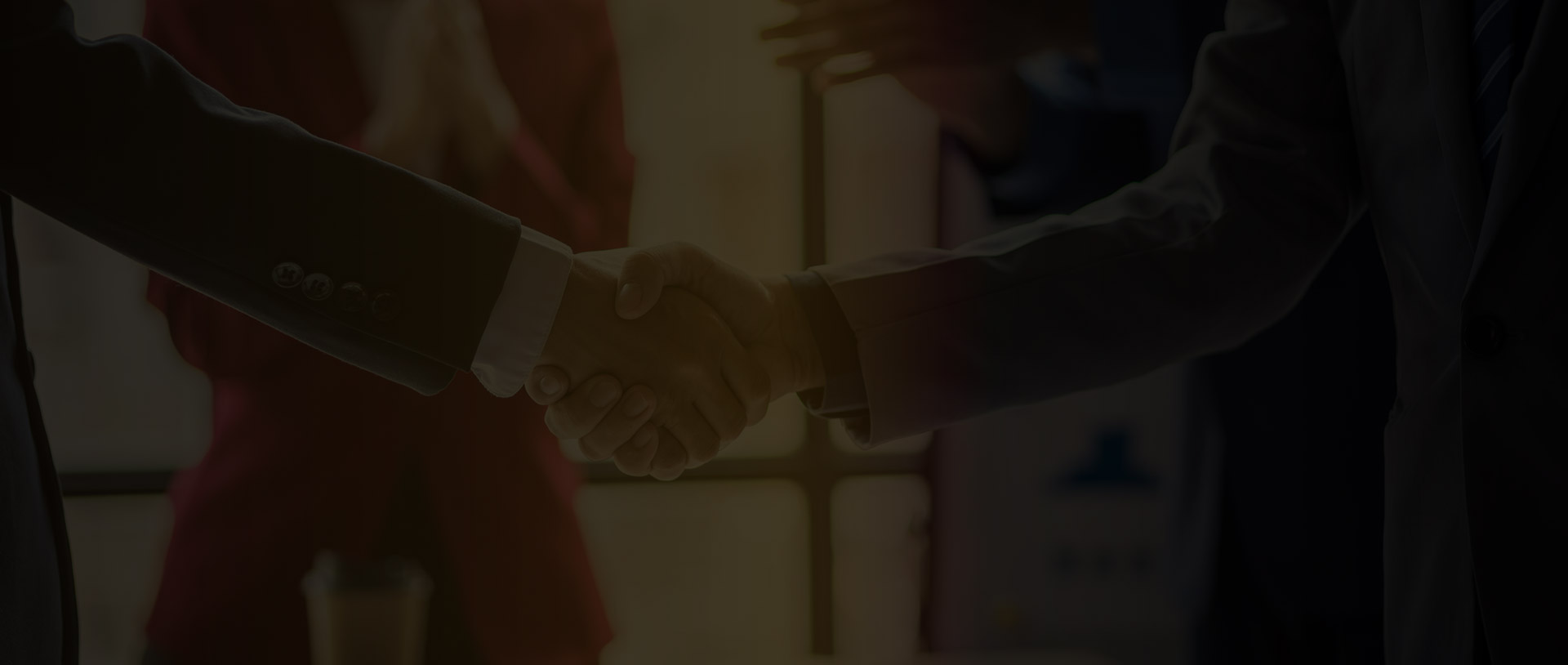 Close-up of two professionals shaking hands, representing a business partnership and collaboration