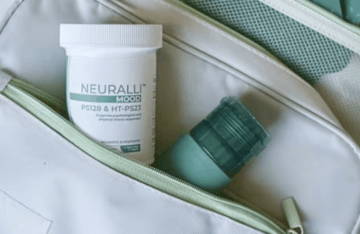 Two skincare products on a light-colored bag.