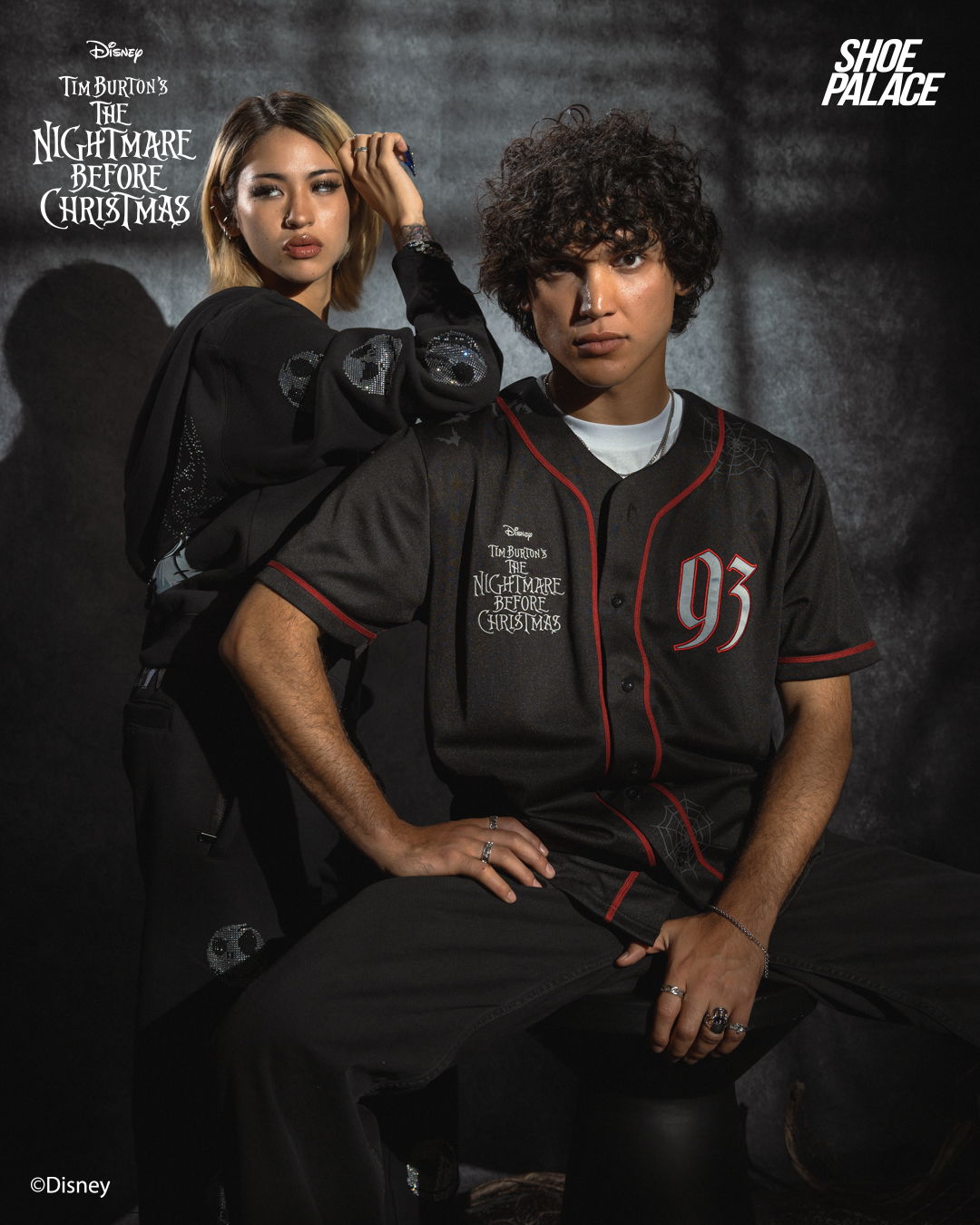 Two young adults posing in themed apparel inspired by 