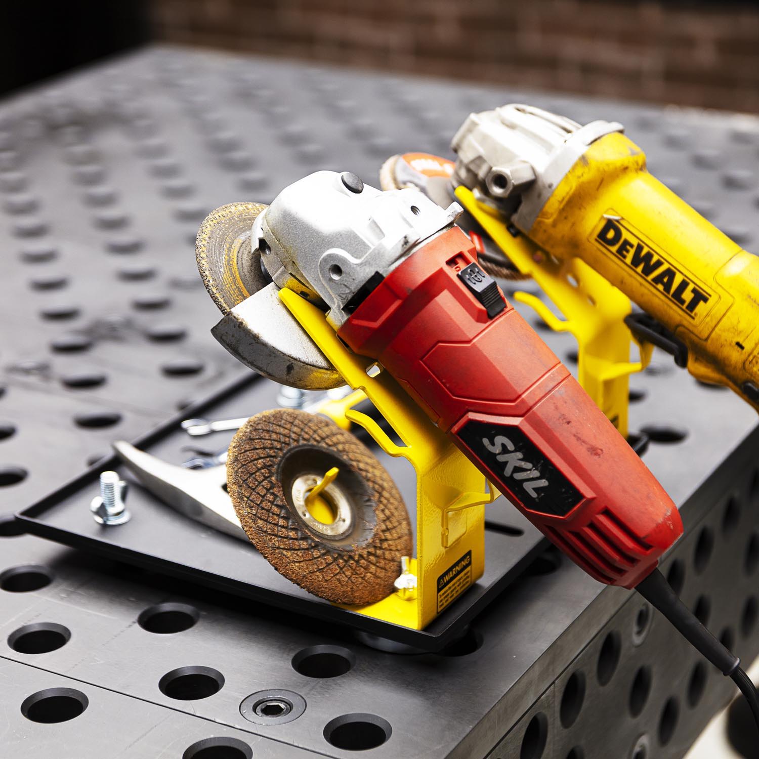 Two power tools on a black work surface.