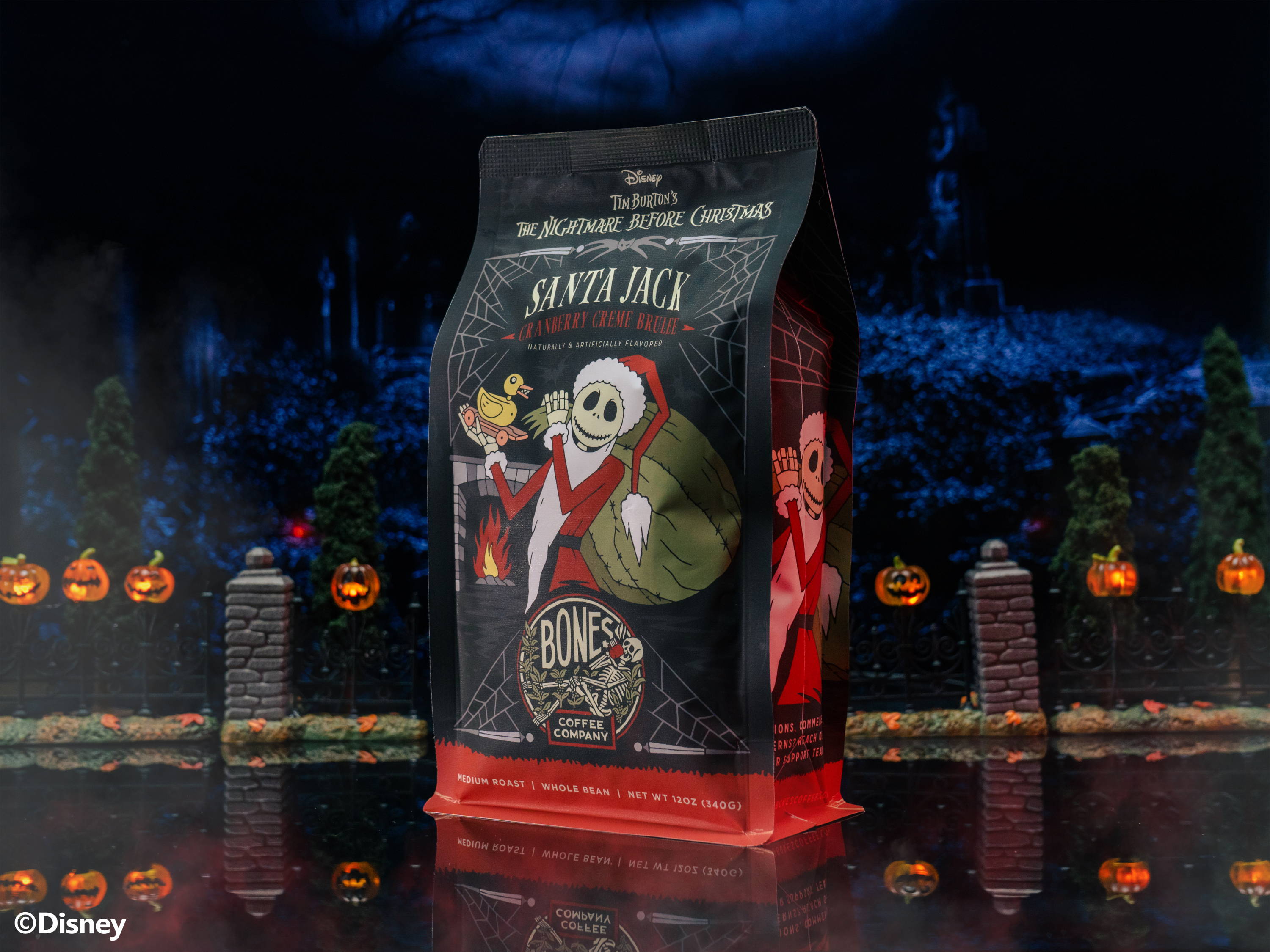 A 12 ounce bag of Bones Coffee Company Santa Jack coffee. Its flavor is cranberry creme brulee and it has Jack Skellington on the art. The bag is inside a toy graveyard.