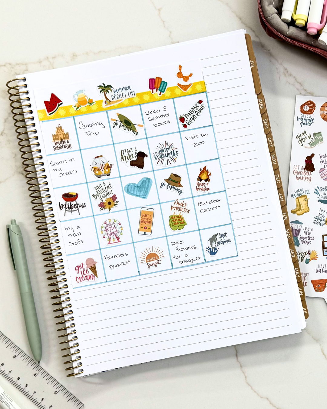 A bingo style grid in a planner with goals for the summer, both handwritten and stickers