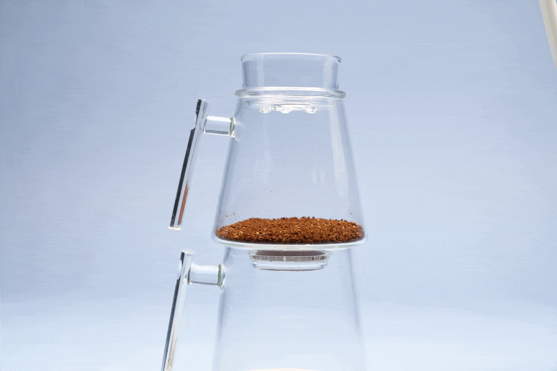 Pouring hot water over the coffee to bloom