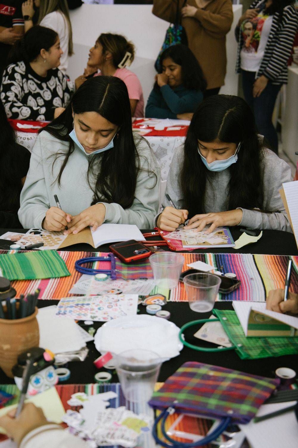 hispanic heritage month x new balance 2 girls working on a notebook