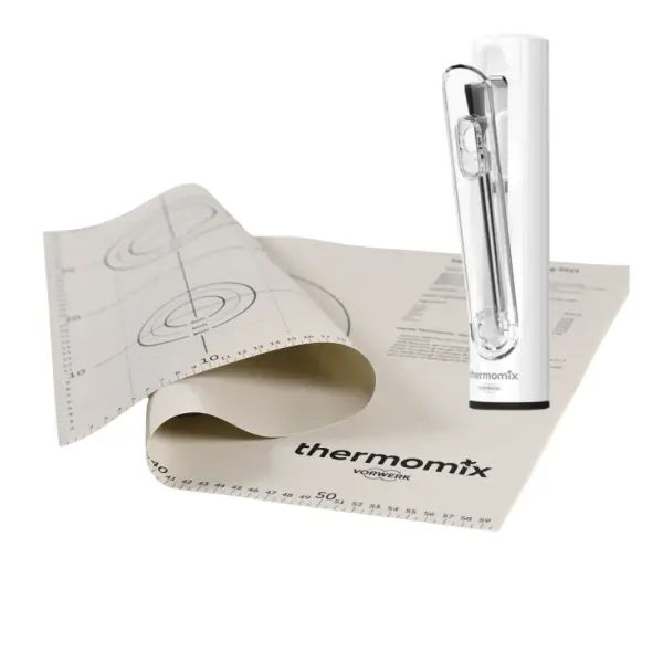 Thermomix cooking mat and measuring stick on a white background.