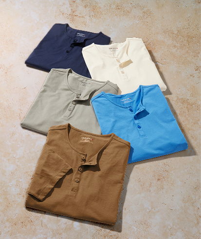 Five assorted collared shirts in various colors arranged on a surface.