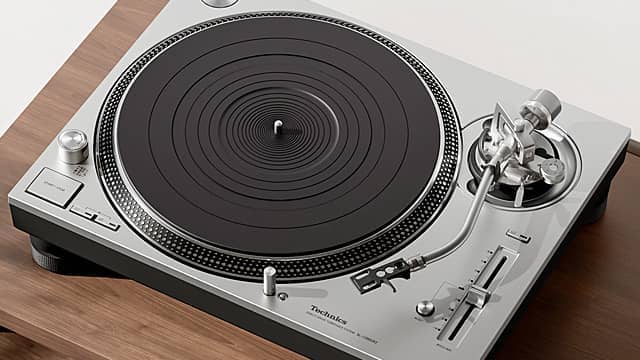 Silver turntable on a wooden surface.
