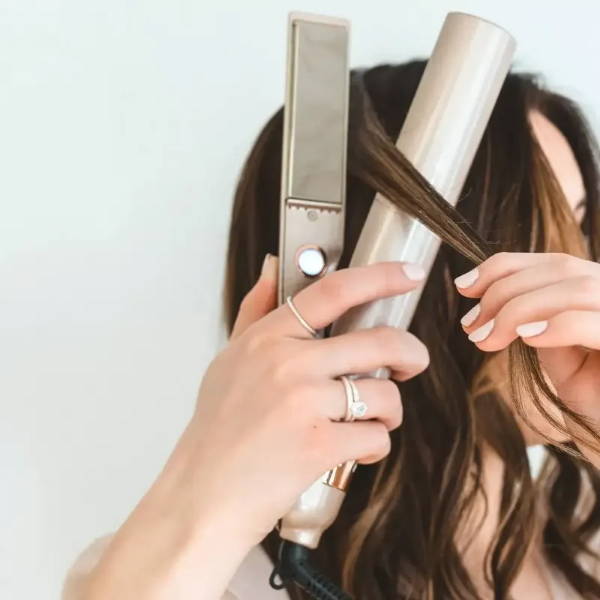 Woman curling hair with TYME Iron Pro