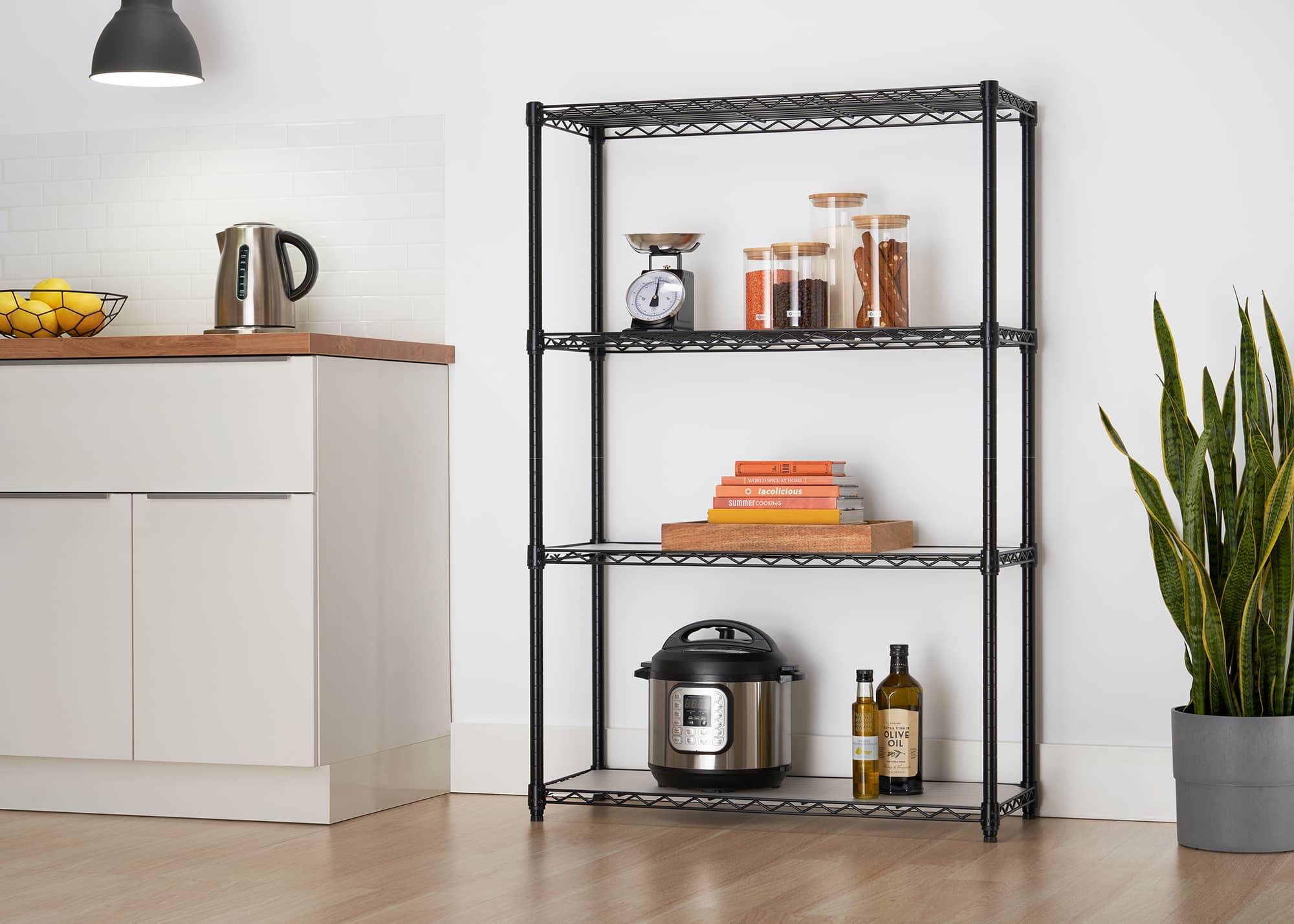 indoor black wire shelving rack in a kitchen filled with glass 