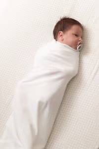 Baby with cuski comforter 