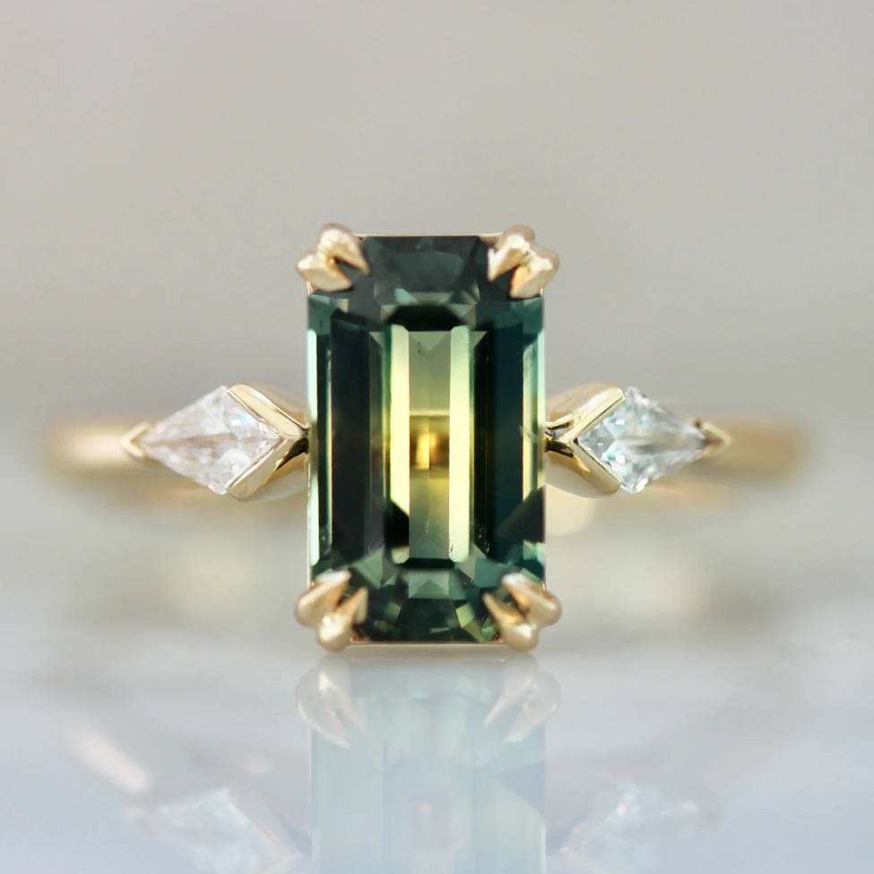 green emerald cut sapphire 3 stone engagement ring