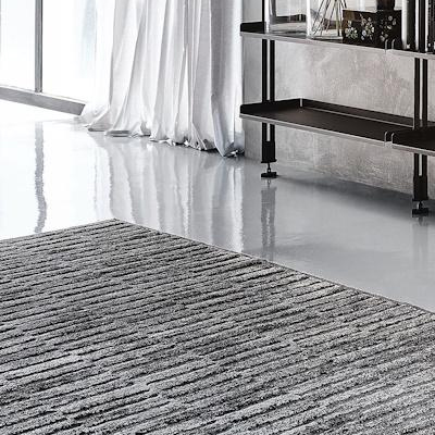 A sleek modern interior with a gray rug and reflective floor.