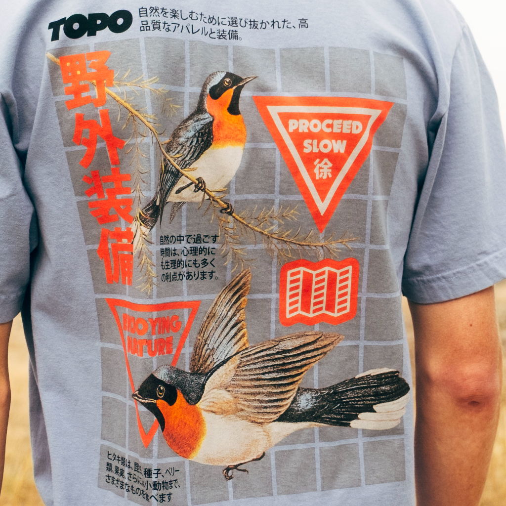 Graphic t-shirt featuring birds and text in red and gray.
