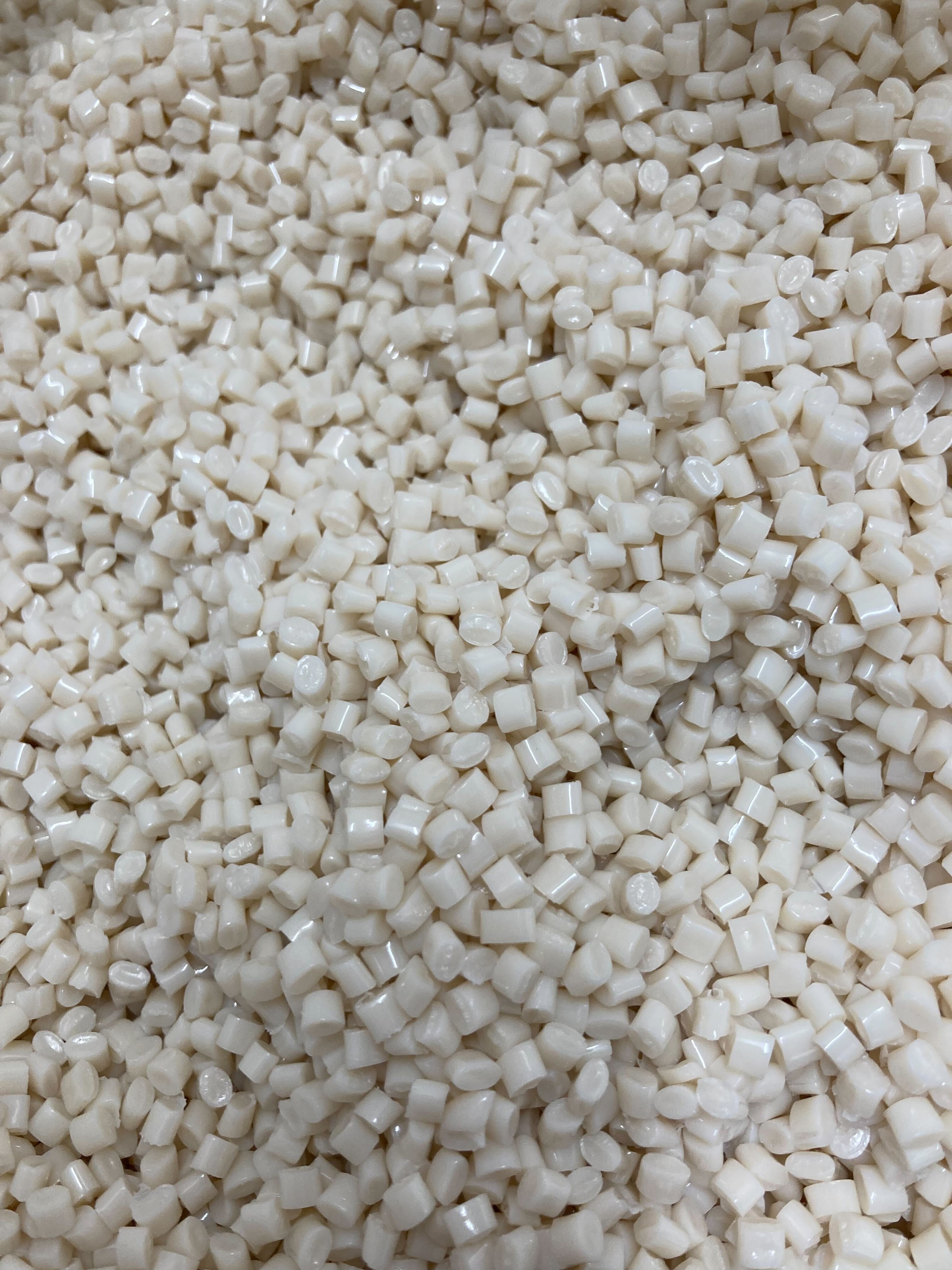 A close-up of small white granules or pellets.
