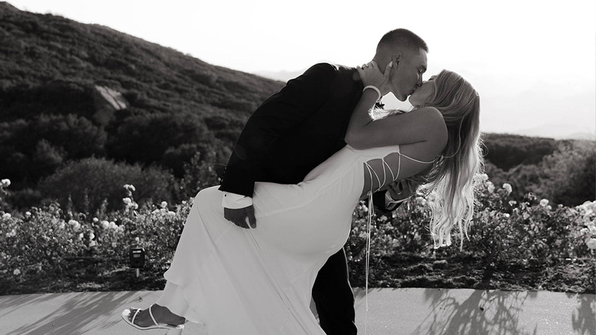Black and white image bride and groom kissing