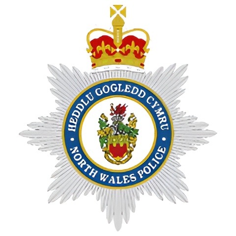 North Wales Police badge with crown and heraldic emblem.