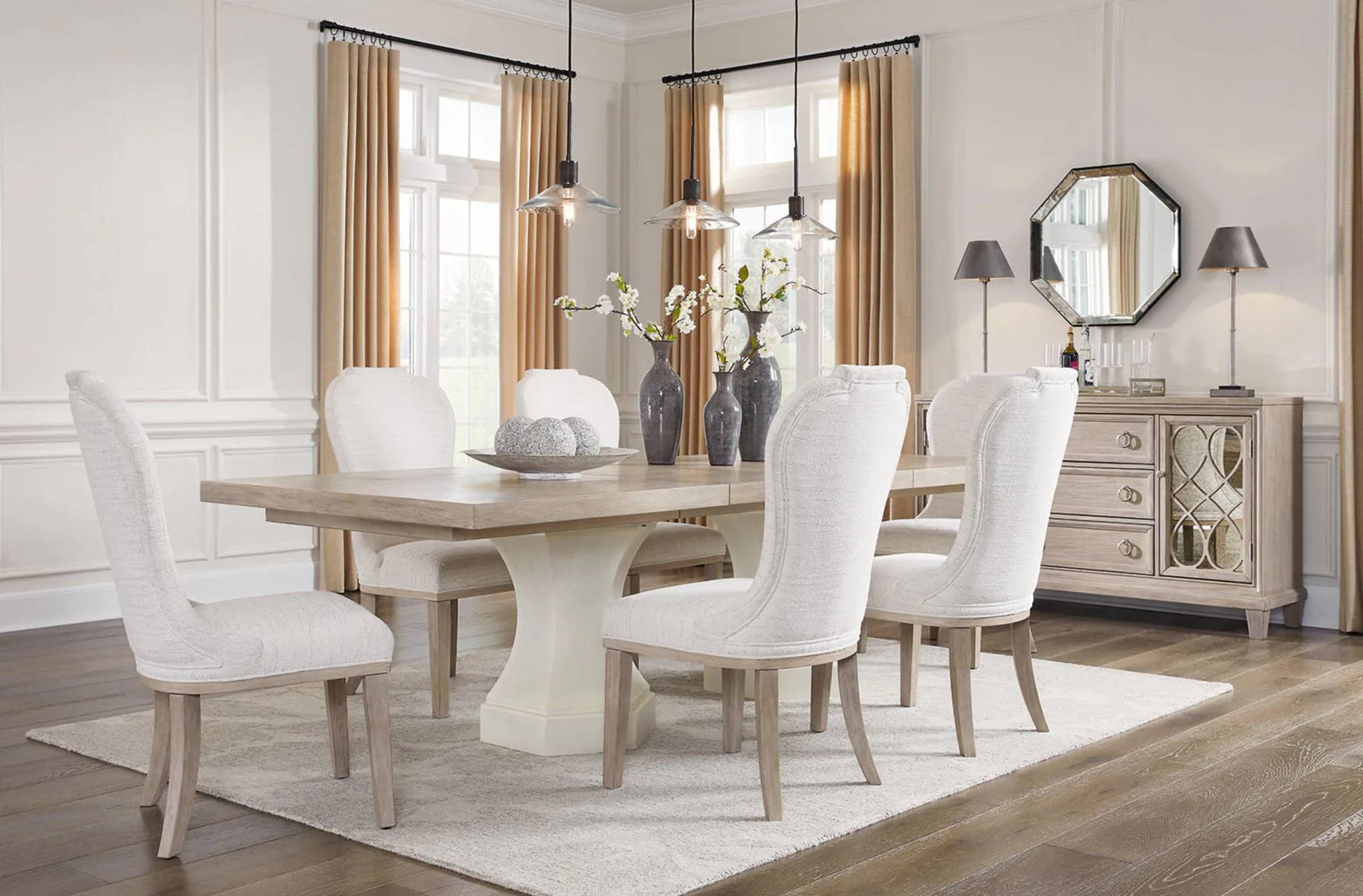 A modern dining room with a table, white chairs, and stylish decor.